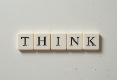 The image features the word "THINK" formed with white letter tiles on a clean white background, symbolizing inspiration, creativity, and motivation in daily life.の素材