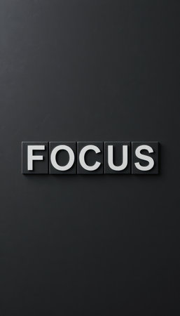 This image features the word "FOCUS" in bold letters against a sleek black background. Ideal for concepts related to motivation and clarity. Perfect for office spaces.の素材