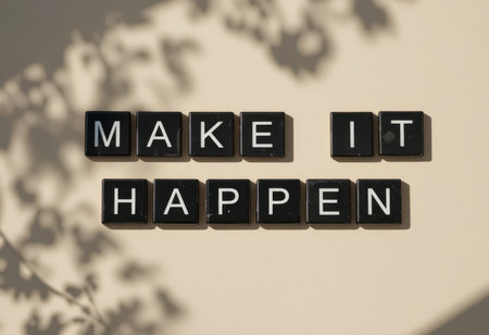 A visually striking arrangement of letters spelling "MAKE IT HAPPEN," casting intriguing shadows on a neutral background, perfect for motivational themes and inspirational designs.の素材