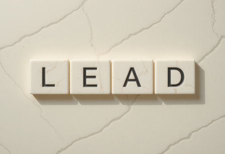 This image shows letter tiles spelling the word "lead" arranged on a light marble surface. The clean design highlights themes of leadership and motivation.の素材