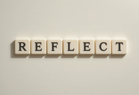 The image features the word "REFLECT" created from letter tiles against a light background, symbolizing inspiration and clarity in thought and expression.の素材