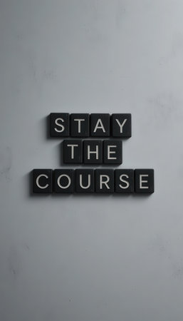 A minimalistic image featuring black tiles arranged to convey the motivational phrase "Stay the Course." Perfect for themes of perseverance and personal growth in various contexts.の素材