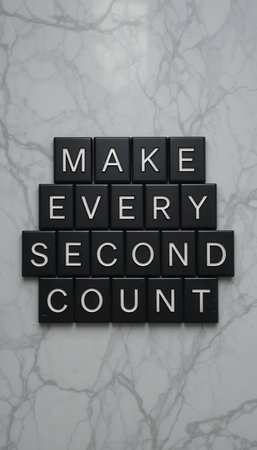 Inspirational letter tiles on a marble surface convey a powerful message about making the most of every moment. Perfect for personal or professional use.の素材