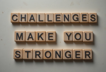 A motivational arrangement of letter tiles stating "Challenges Make You Stronger," perfect for inspiring resilience and personal growth in various contexts.の素材