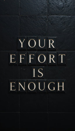 A striking image displaying motivational text "Your Effort Is Enough" in stylish tiles against a dark background, perfect for inspiring personal growth and positivity.の素材