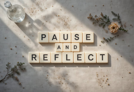 A serene flat lay image showcasing the words "Pause and Reflect" crafted with natural elements. Ideal for promoting mindfulness and wellness principles.の素材