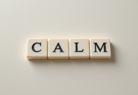 The image showcases letter tiles that spell out the word "calm," set against a soft background, embodying tranquility and relaxation. Perfect for wellness themes.の素材