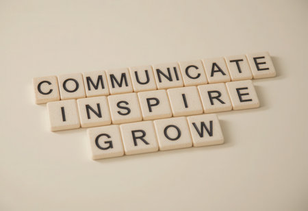 This image features wooden letters arranged to spell "communicate, inspire, grow," symbolizing key elements of personal and professional development.の素材