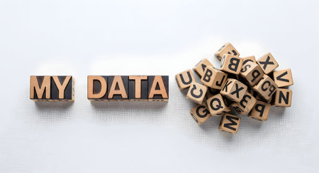 The word media spelled with wooden cubes on a white fabric background.の素材