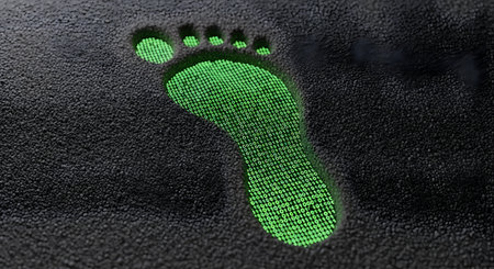 Green footprint on a black background. Footprint in the dark.の素材