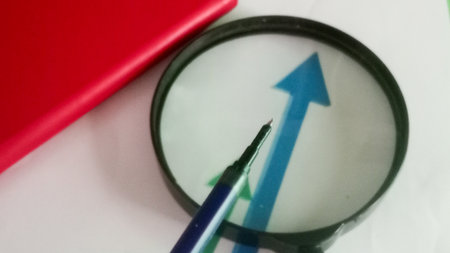 Magnifier and pen on the white background. Close-up.の写真素材