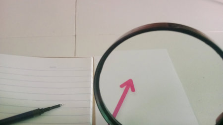 Magnifying glass and notebook with pen on the table. Close upの写真素材