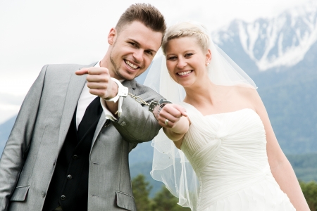 bride and groom bounded with handcuffsの写真素材