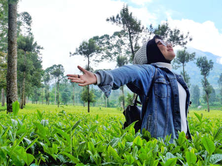 Wonosobo, Indonesia, January - 26 - 2020 . Tambi , a girl who is enjoy a vocation in a tea garden,...