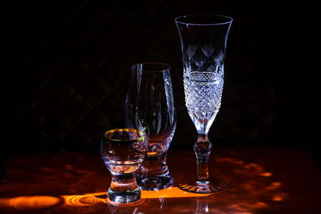 Glasses for wine and champagne and glasses for strong drinks on the bar.