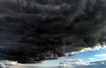 Waiting for a hurricane. Black clouds in the blue sky. Impending stormの写真素材
