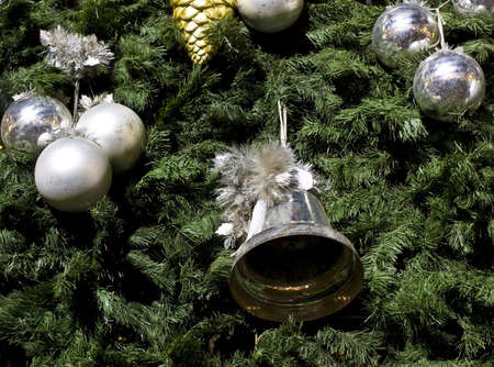 Christmas decorations - silver bell and balls on fir-tree.の写真素材