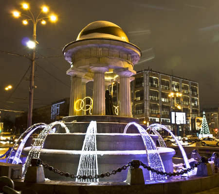 Moscow, Russia - January 04, 2012: electric winter fountain with sculptures of poet Pushkin and his wife Nataly on square Nikitskiye gates.のeditorial素材