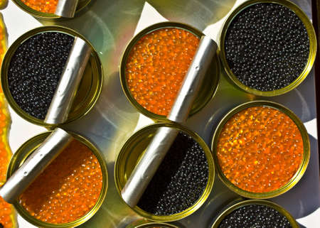 Tins (cans) with red and black caviar, opened.の写真素材