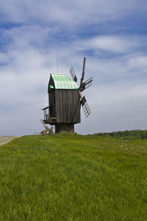 Pirogovo, Ukraine - May 05, 2010: Wooden windmill on green meadow, recorded in outdoors museum of national architecture in Pirogovo, near Kiev, capital of Ukraine.のeditorial素材