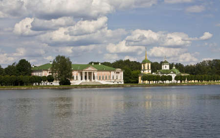 Moscow, Russia - June 19, 2010: palace of earl Sheremetyev Kuskovo and church on bank of lake.のeditorial素材