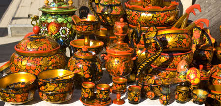 Traditional Russian wooden hand painted dishes, in hohloma style.