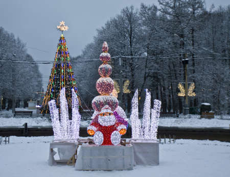 Moscow, Russia - January 02, 2012: Christmas tree and electric sculpture of Santa Claus in park Sokolniki.のeditorial素材