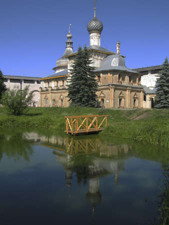 Famous historical town Rostov in Russia, orthodox church inside Kremlin (town fortress) with reflection in water of pond.の写真素材