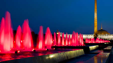 Moscow, illuminated fountains and Historical museum of Second World War in cultural centre  Poklonnaya hill  on Kutuzovskiy prospectus avenue at night のeditorial素材