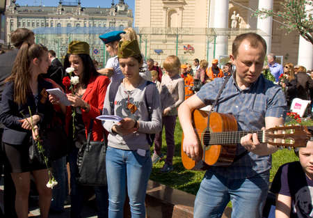 MOSCOW - MAY 9, 2014  Holiday Victory Day devoted to victory in Second World War, people sing war songs on the street near Big Theatre 	のeditorial素材