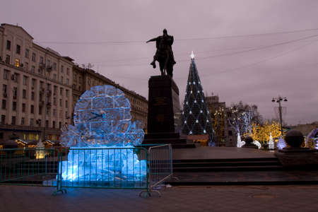 MOSCOW - DECEMBER 26, 2013: Ice clock and Christmas tree on Tverskaya street near monument to king Yuriy Dolgorukiy.のeditorial素材