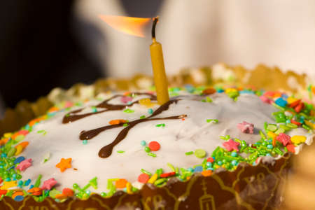Easter cake with candle and eggs.の写真素材