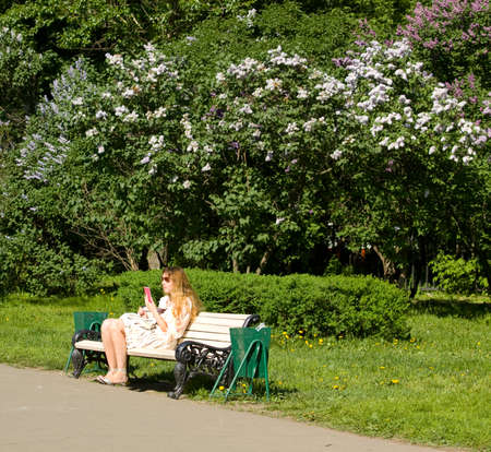 MOSCOW - MAY 16, 2014: people resting in park Lilac garden, garden has been opened in 1954 and has many unique sorts of lilac, selected for this garden and sold all over the world.のeditorial素材
