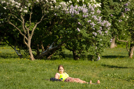 MOSCOW - MAY 16, 2014: people resting in park Lilac garden, garden has been opened in 1954 and has many unique sorts of lilac, selected for this garden and sold all over the world.のeditorial素材