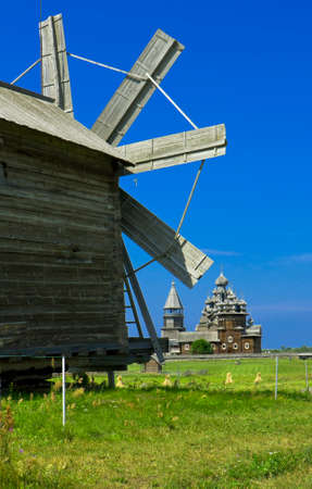 Old wooden windmill and churches on island Kizhi on Onega Onezhskoye lake in region Karelia on North of Russia, UNESCO World Heritage site.のeditorial素材