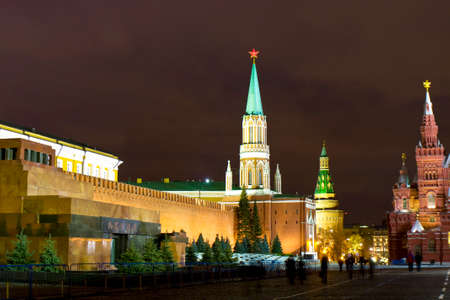 Moscow, Russia - December 19, 2013: Saint Nicholas tower and Corner Arsenal towers of Kremlin fortress, mausoleum of Lenin and part of Historical museum on Red square at night.のeditorial素材