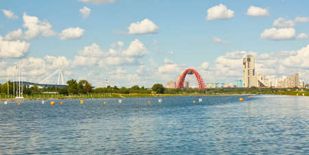 MOSCOW - AUGUST 17, 2013: ice palace Krylatskoye, has been built in 2004 year,  Picturesque bridge and modern skyscrapers on bank of Moskva-river in region Krylatskoye.のeditorial素材
