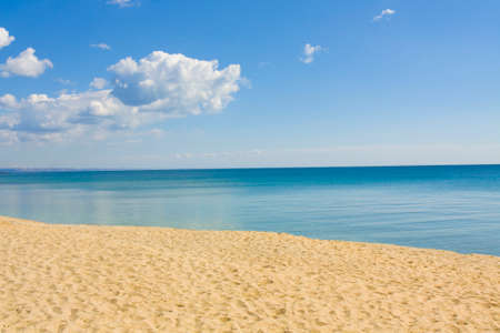 Seascape with calm blue sea, little clouds and sandy beach, recorded in Saint Constantine and Saint Helen resort, Bulgaria.の写真素材