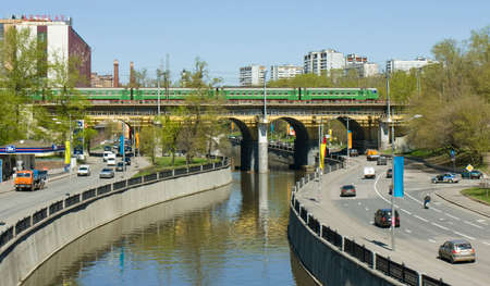 MOSCOW - MAY 07, 2013: metro underground train goes by Kostomarovsky bridge on Yausa river, has been built in 1941 year.のeditorial素材