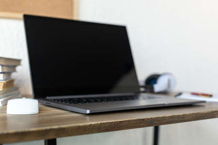 Laptop or notebook at table in office.  Workplace for online study