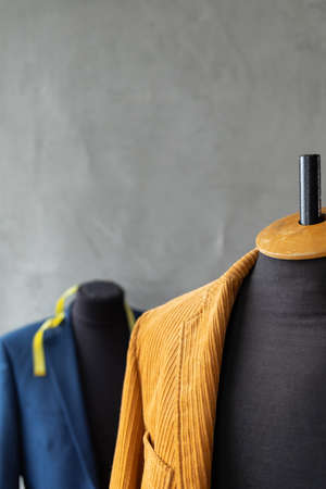 Suit jacket on tailor mannequin and tape measure. Concept of clothes atelier workplaceの写真素材