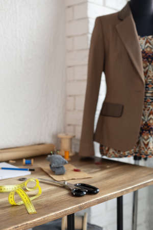 Sewing accessories with supplies or tools and tailor mannequin. Concept of clothes atelier workplaceの写真素材