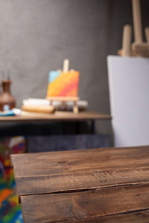Front view of empty wood table and artist tools. Paintbrush and art painter supplies on desk background texture. Painting in artist workplaceの写真素材
