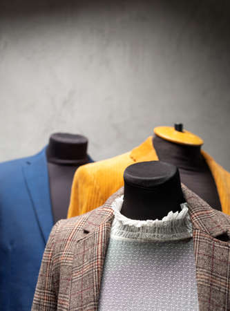 Suit jacket on tailor mannequin. Concept of clothes atelier workplace