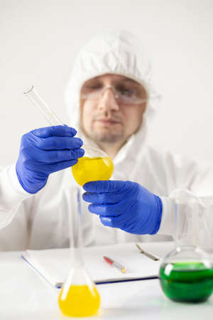 Scientist holding test tube with liquid reagent. Doctor and chemical laboratory   glasswareの写真素材