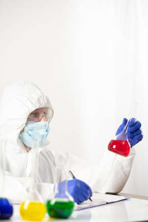 Scientist holding test tube with liquid reagent. Doctor and chemical laboratory   glasswareの写真素材
