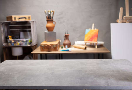 Front view of empty table and artist tools. Paintbrush and art painter supplies on desk background...