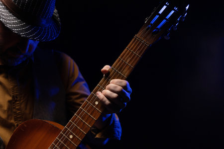 Man playing acoustic guitar. Musician in record studio holding classic guitarの写真素材