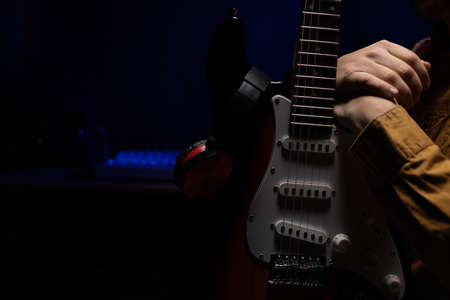 Man playing electric guitar. Musician in record studio holding electric guitarの写真素材