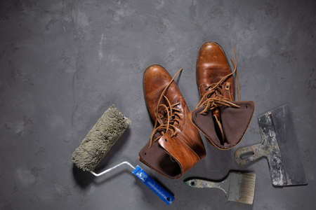 Worker boots and construction tools at cement floor. Tool construction concept on concrete...